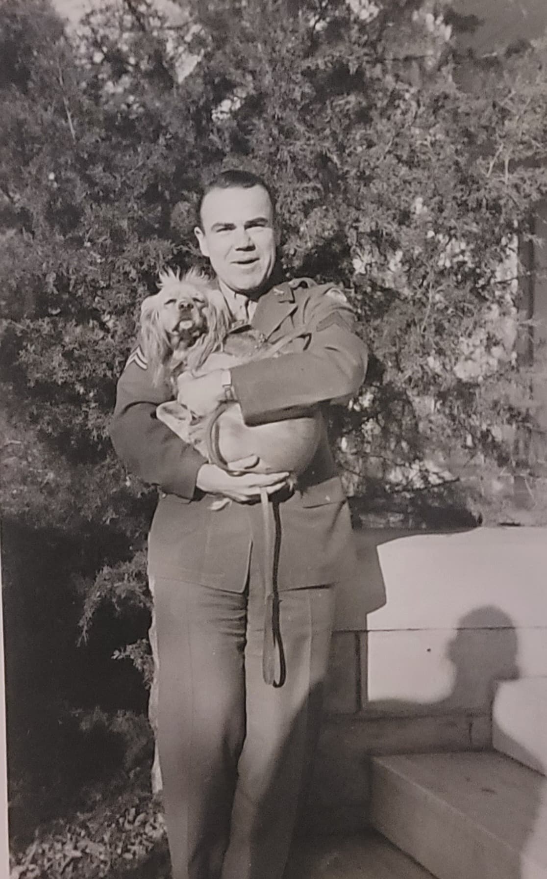 A soldier holding Corporal Honey
